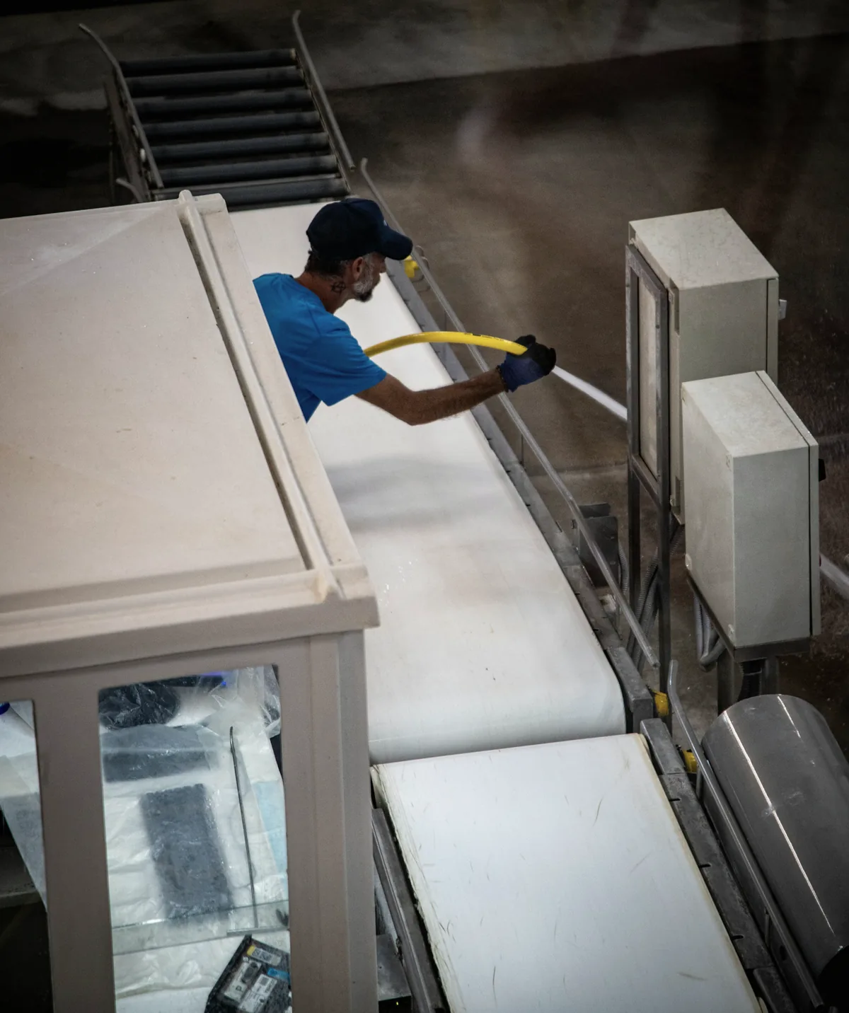 Technician cleaning industrial production equipment